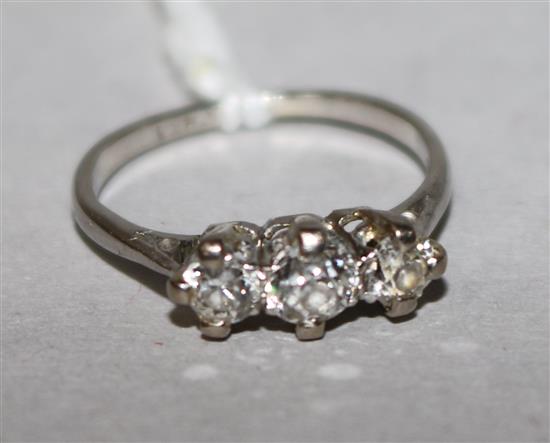 A platinum and three stone diamond ring, size H.